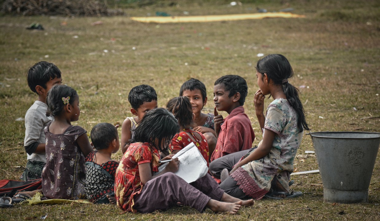 A group of children sitting together outdoors